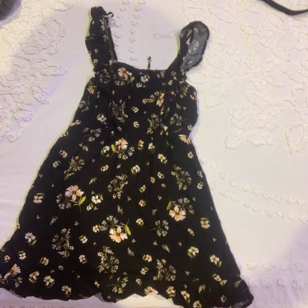 A floral dress that ties in the back, in size small.